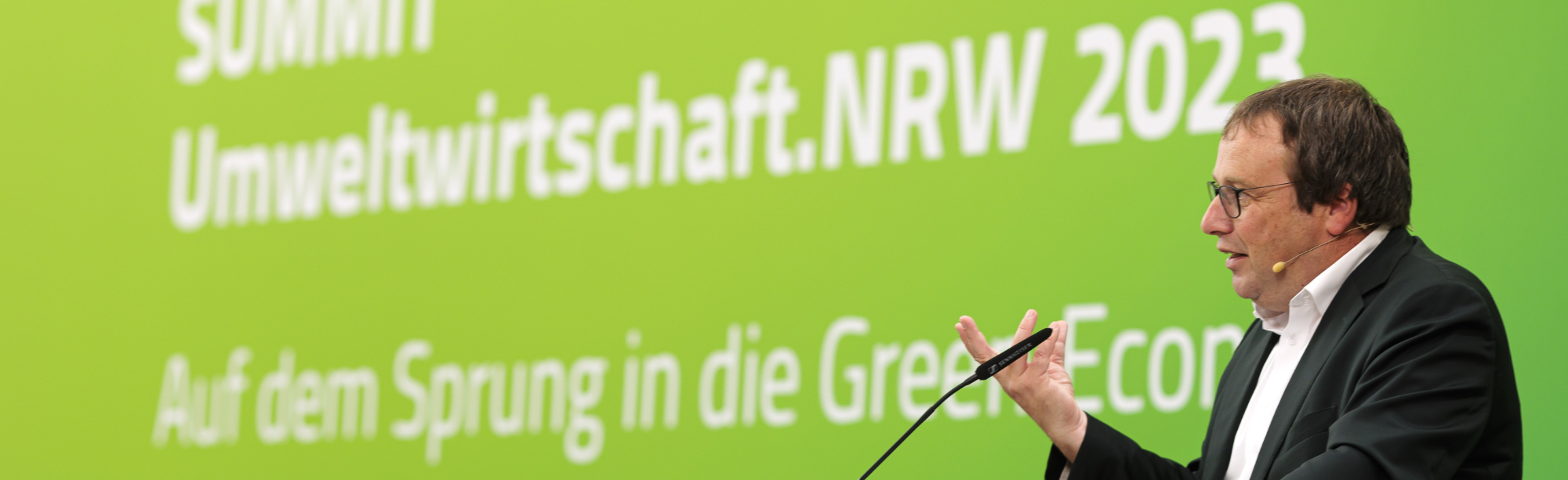 Minister Oliver Krischer am Rednerpult beim Summit Umweltwirtschaft 2023