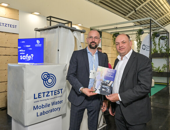 Staatssekretär Haase am Messestand im Gespräch